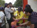 Jolanta administers vaccination drops to an Indian child